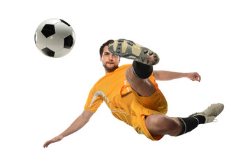 Fototapeta na wymiar Soccer Player Kicking Ball in Midair