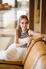 Beautiful girl in a white dress in a beautiful interior.