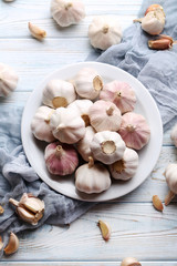 Garlic in plate on blue wooden table