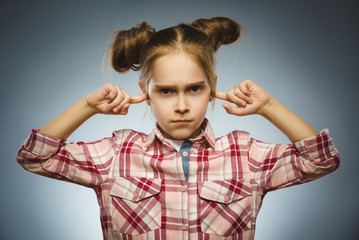 worried girl covering her ears, observing. Hear nothing