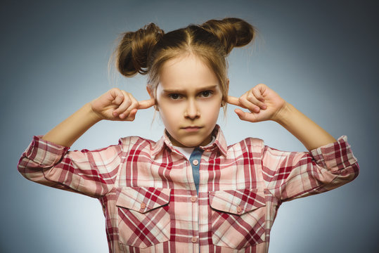 worried girl covering her ears, observing. Hear nothing