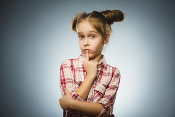 Closeup Thoughtful girl with Hand at head isolated on Gray