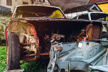 Abandoned old rusty body and parts of retro car