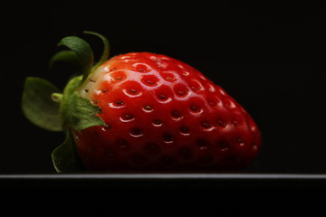 strawberry on black dish 