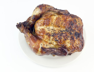 Top view of simple roast chicken on a platter.