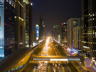 Fototapeta na wymiar Night view of Dubai city with roads, skyscrapers and bright lights