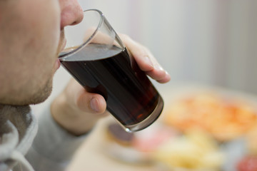 Drinks, people and lifestyle concept. close up of man drinking sweet-fizzy drink.