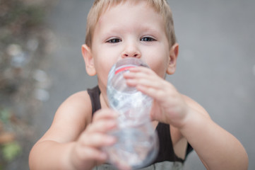 Little boy drink water from bottle