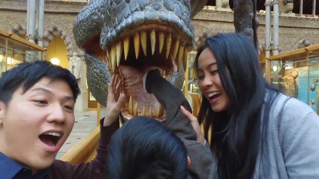  Happy family having fun in museum & video recording themselves