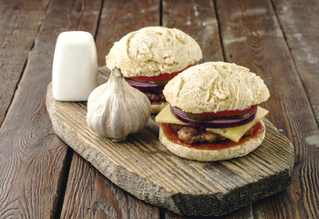 homemade veggie burger in a bun with sesame seeds of beer. delicious fast food for vegans. on a wooden background
