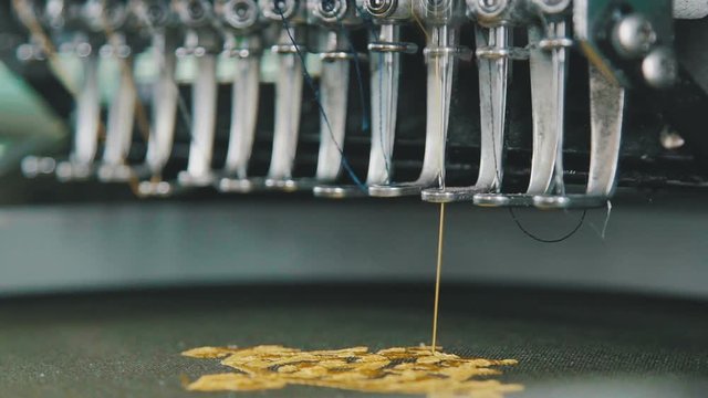 Industrial embroidery equipment. Machine embroidery work. Machine embroidery is an embroidery process whereby a sewing machine. Textile - Professional and industrial embroidery machine.