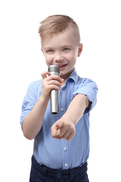 Cute little boy with microphone on white background