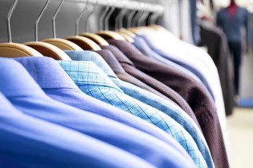 Rack with shirts in modern shop, closeup
