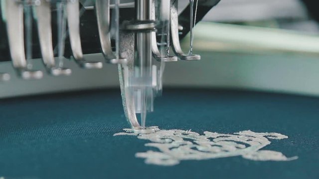 Machine embroidery is an embroidery process whereby a sewing machine or embroidery machine is used to create patterns on textiles. Needle with thread. Embroidery needle