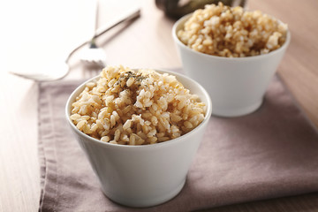 Two bowls of brown rice on napkin