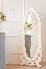 beautiful beige oblong mirror with patterns in the Studio with white walls interior colors