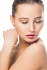 Fototapeta premium Beauty Woman Portrait. Beautiful Spa Girl Touching her Face. Perfect Fresh Skin. Pure Beauty Model Female looking at camera. Youth and Skin Care Concept. Isolated on white background