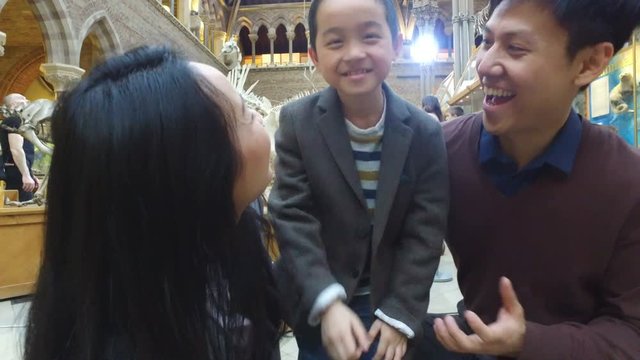  Happy family having fun in museum & video recording themselves