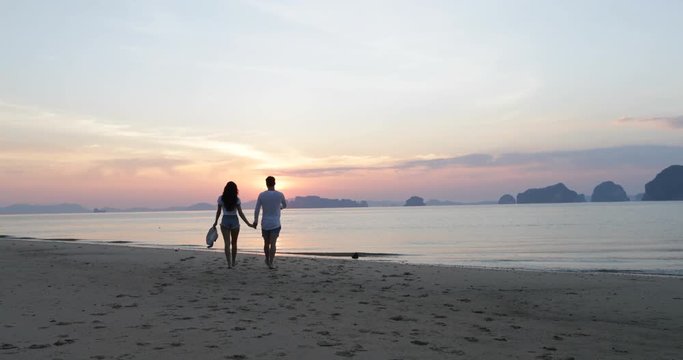 Young Couple On Beach At Sunset, Man And Woman Walking Seaside, Tourists Sea Vacation Slow Motion 60