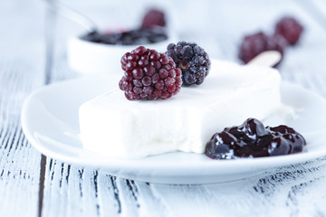 Homemade blackberry ice lolly on a rustic background