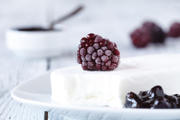 Homemade blackberry ice cream or popsicles decorated green mint leaves on teal rustic table, frozen fruit juice