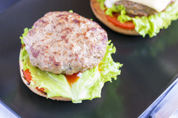 Homemade hamburger on dark plate
