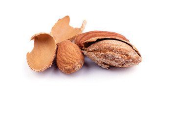 salted almonds in shell close up on white background isolate