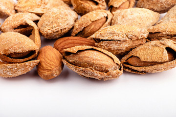 salted almonds in shell close up on white background