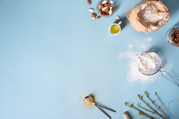 Baking ingredients for pastry on the blue background. Cooking cakes or bread concept. Top view,...