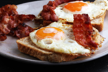 Ham and Egg. Bacon and Egg. Salted egg and sprinkled with black pepper. English breakfast.