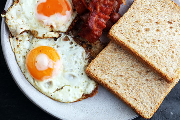 Ham and Egg. Bacon and Egg. Salted egg and sprinkled with black pepper. English breakfast.
