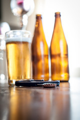 beer bottles and a glass on a table
