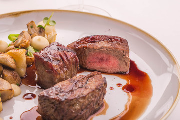Beef fillet, three pieces on a plate with sauce 
