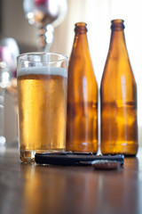 beer bottles and a glass on a table