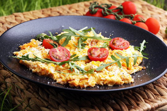 Traditional breakfast - fried eggs,ruccola, tommato- - diet concept scrambled eggs