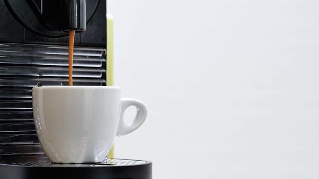 girl take with her hand a white cup full of coffee made with coffee maker in a on a clear background at the breakfast