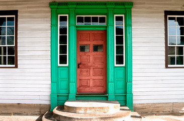 Naklejka premium Red Antique Door Boardered woth Green, interesting reflection in door window