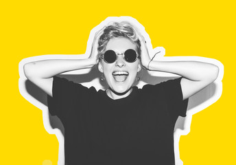 Stylish fashion blonde with short hair colorful collage. Crazy girl in a black t-shirt and rock sunglasses scream holding her head. Rocky emotional woman. white toned. yellow background, not isolated