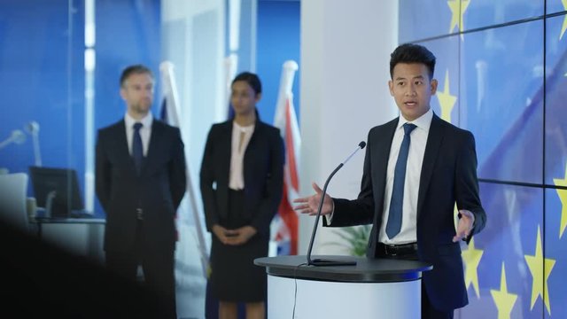  Politician making a speech at press conference, EU flag in background