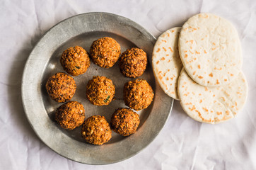 Crispy falafel and Arab pita bread against white background. Selective focus.