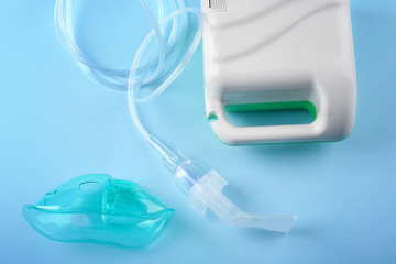 Compressor nebulizer with mouthpiece on color background