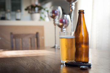 beer bottles and a glass on a table