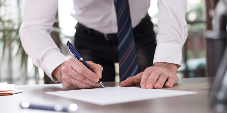 Businessman signing a document