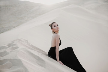 Beautiful sexy asian woman model on a dune of desert