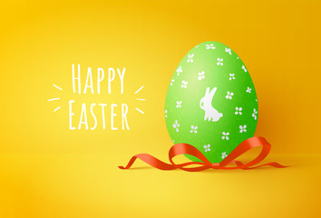 Green easter egg with cute bunny