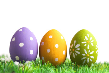 Bunch of easter eggs in pastel colors on grass