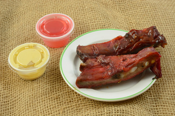 Take out BBQ Spare Ribs appetizer with mustard and sweet and sour sauce