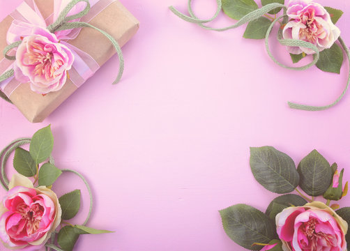 Feminine background with gift and silk roses
