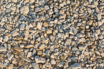 Background of many small stones of different colors, gravel or crushed stone close-up texture