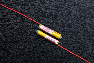 Rocket firework close up photo on the black color leather surface as a background represent the...